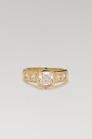 Mara ring, gold plated, front view of the bezel-set cushion-cut centre stone with four smaller stones in the band