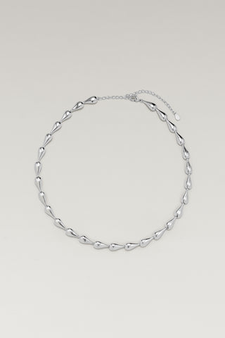 Riva necklace, silver-tone, lying in a circle with the clasp and extender at the top, hollow teardrop links