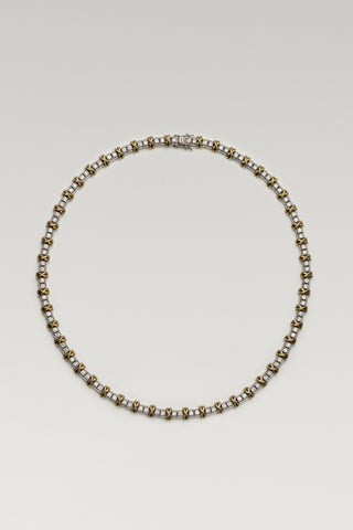 Renata necklace, rhodium and gold plated, lying in a circle with the box clasp at the top