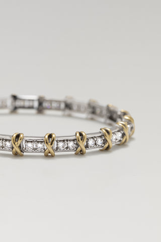 Renata bracelet, rhodium and gold plated, angled close-up of the cubic zirconia links and gold crosses