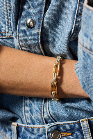 Allegra bracelet, gold and rhodium plated, worn on the wrist across a denim jacket