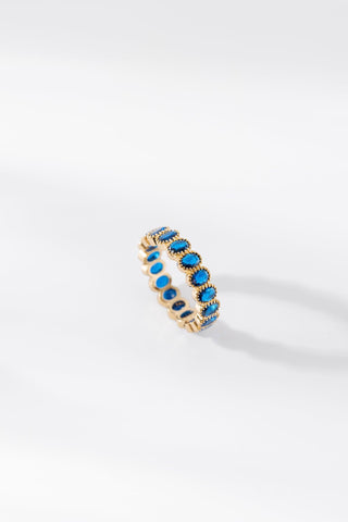 Aurora gold ring featuring oval blue gemstones on a white background