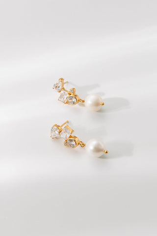 Belle bridal earrings with crystal detailing and pearl drop on white background