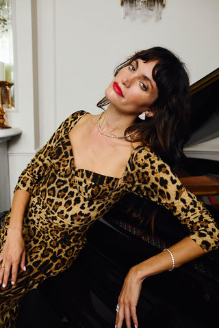 Model wearing Chiara Earrings, modern gold stud earrings with textured pavé crystal surface.