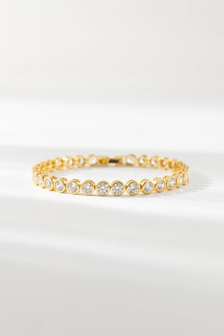 Round Tennis Bracelet by One Dame Lane, classic gold tennis bracelet set with round-cut stones.